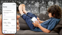 boy sitting on the couch using a device connected to the Managed Wifi system
