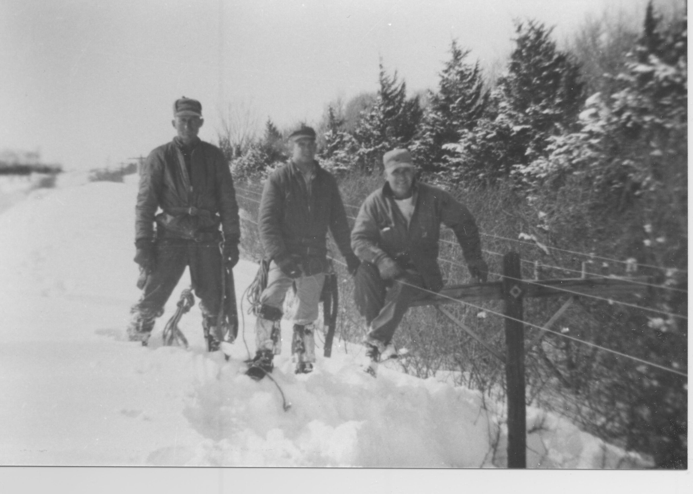 ice storm in hamilton county in 1976 of hamilont employees on a snow drift standing next to a telephone line.